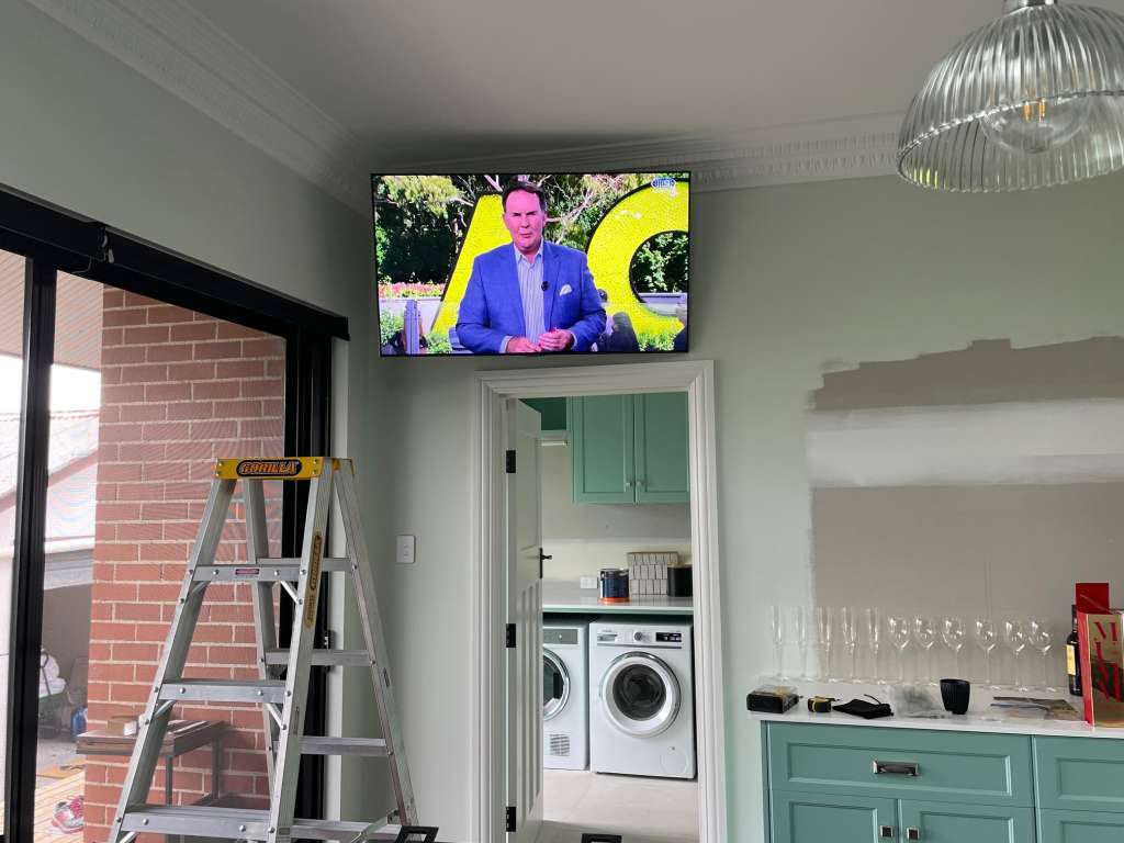 Samsung TV wall mounted in the kitchen above the doorway